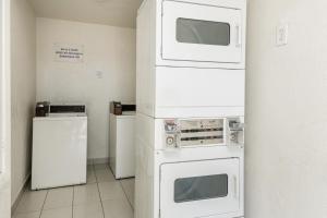 three microwaves stacked on top of each other in a room at Motel 6 Fort Worth, TX - North in Fort Worth