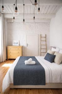 a bedroom with a bed with a towel on it at Serpa Beach House in Matosinhos