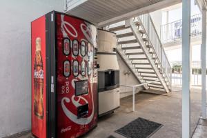 a red refrigerator in a room with a staircase at Motel 6 Fort Worth, TX - North in Fort Worth