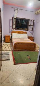 a bedroom with a bed with a wooden headboard at Ighbola Ouzoud in Ouzoud