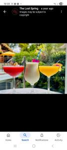 two cocktails in glasses sitting on a table at Kupe Boutique House with ensuite free wifi in Whitianga