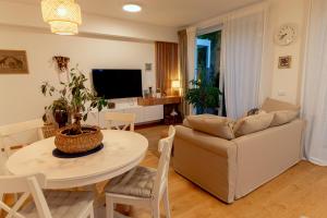 a living room with a table and a couch at Anur Apartment in Ptuj