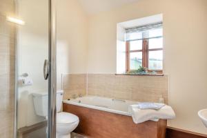 a bathroom with a tub and a toilet and a sink at 3 Bed in Whitwell oc-h33498 in Whitwell +25 photos