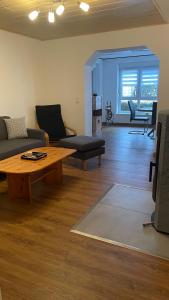 a living room with a couch and a coffee table at Zum Talblick in Limbach