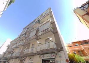 a building with balconies on the side of it at Home trani in Trani