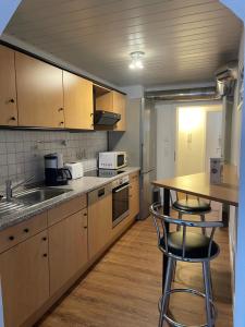 a kitchen with a counter and a sink and a table at Zum Talblick in Limbach