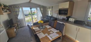 a living room with a dining table and a kitchen at Graham's Dream in Heysham