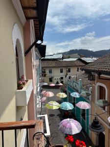 a balcony with a bunch of umbrellas on a street at Casa La Ronda in Quito