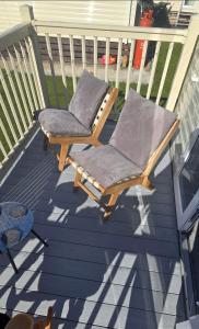 a rocking chair sitting on a deck at Graham's Dream in Heysham