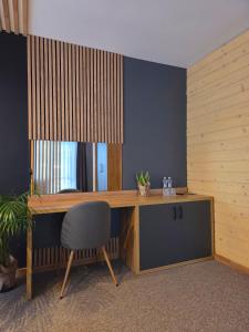 a wooden desk with a chair in a room at Complex Hyzhky in Yaremche