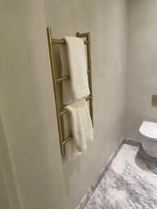 a bathroom with towels hanging on a wall at The Brompton Residence Hotel in London