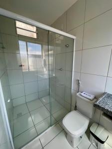 a bathroom with a toilet and a glass shower at Hotel Letiva Centro in Sobral +51 photos