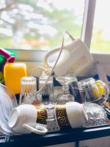 a table with dishes and a hairbrush and a phone at Jnelis Home in Yaoundé +2 photos