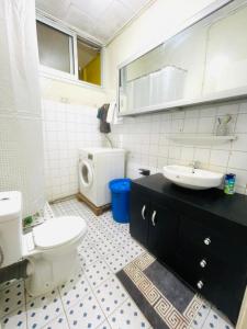 a bathroom with a toilet and a sink at Jnelis Home in Yaoundé