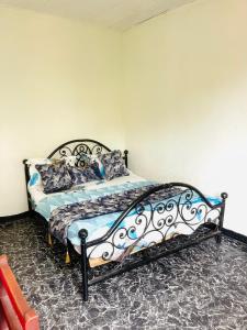 a bedroom with a bed in a room at Jnelis Home in Yaoundé