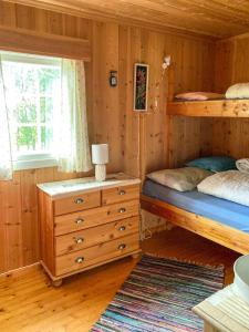 a bedroom with two bunk beds and a window at Simple Mountain Cabin Near Vinstra in Vinstra +6 photos
