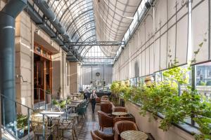 a greenhouse with tables and chairs and plants at Hotel José Nogueira in Punta Arenas
