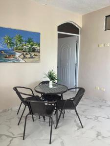 a table and chairs in a room with a painting at Apartamento Piro 1 - 4 pax - a 5 Min De La Playa in Las Galeras +21 photos