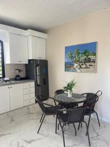 a kitchen with a table and chairs and a refrigerator at Apartamento Piro 1 - 4 pax - a 5 Min De La Playa in Las Galeras