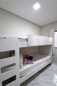 a white bunk bed in a white room at Casa 3 Quartos Ar Condicionado , Area de Churrasco in Petrolina
