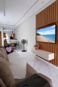 a living room with a large screen with a view of the beach at Casa 3 Quartos Ar Condicionado , Area de Churrasco in Petrolina
