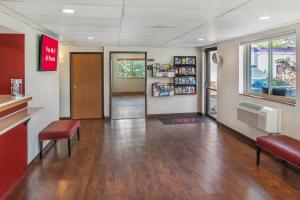 a lobby with a waiting room with aperature at Red Roof Inn Queensbury in Queensbury