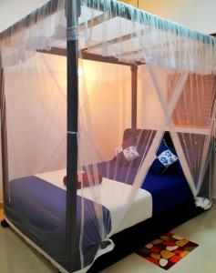 a bed with a canopy in a room at Yala Eagle Nest & Safari in Tissamaharama