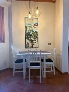 a dining room table with chairs and a painting on the wall at Lovely Stay in Sesto Fiorentino