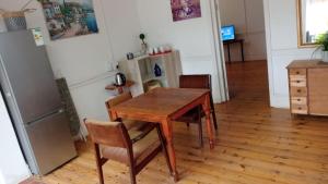 a dining room with a wooden table and chairs at Palm Terrace Guesthouse in Durban
