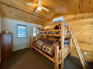 a bedroom with two bunk beds in a log cabin at Riverfront Motel & Cabins in Thompson Falls +112 photos