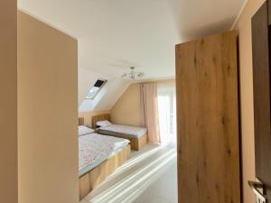 a bedroom with two beds and a window at Między Wzgórzami Korbielów in Korbielów