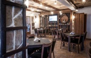 a restaurant with wooden tables and chairs and a television at Apartman in Danilovgrad