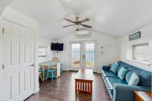 a living room with a blue couch and a table at Live Laugh Lake - A in Rushville