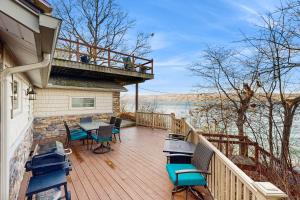 a deck with chairs and a table on a house at Live Laugh Lake - A in Rushville