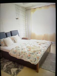 a bedroom with a bed with a blanket on it at Airport Luxury Residence Taj collection 1 in Casablanca