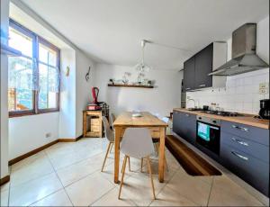 a kitchen with a wooden table and chairs in it at Rooftop Carcente in San Siro +12 photos
