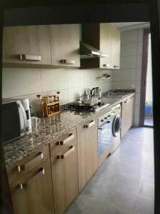 a kitchen with a stove and a dishwasher at Airport Luxury Residence Taj collection 1 in Casablanca