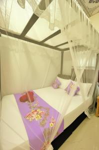 a bedroom with a bed with a canopy at Yala Eagle Nest & Safari in Tissamaharama +37 photos