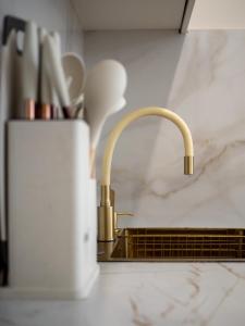 a kitchen counter with a sink and two faucets at Smart Lux 200 in Zhezdi +32 photos