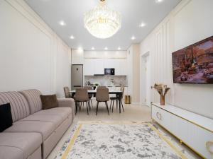a living room with a couch and a dining room at Smart Lux 200 in Zhezdi
