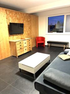 a living room with a couch and a tv at Haus Schloßbergblick in Leutschach