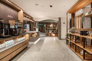a store with a long hallway with tables and chairs at Hotel Stegerbräu in Radstadt