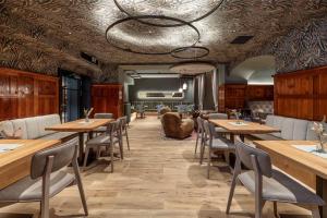 a dining room with wooden tables and chairs at Hotel Stegerbräu in Radstadt