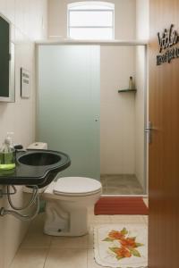 a bathroom with a toilet and a sink and a shower at Quarto - Room Econômico da Maricotinha - No Air Cond in Manaus +11 photos
