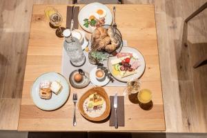 a table with plates of food on top of it at Hotel Stegerbräu in Radstadt +113 photos