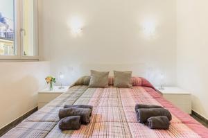 a large bed with two pillows on it in a bedroom at Malpensa sweet home in Busto Arsizio