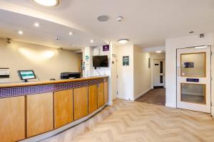 a lobby of a hospital with a reception counter at ALTY Hotel in Broadheath