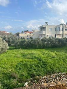 a large yard with a house in the background at Renas' Apartments in Chios island in Chios +10 photos