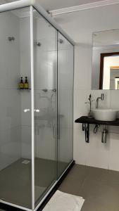 a bathroom with a glass shower and a sink at Pousada VilaZinha in Vila Velha +39 photos