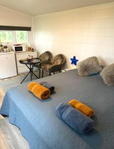 a bedroom with a large bed with pillows on it at Baksas Luxury Campers in Selfoss